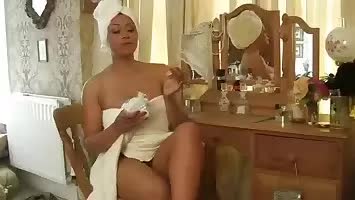 Busty chick putting on cosmetic lotion